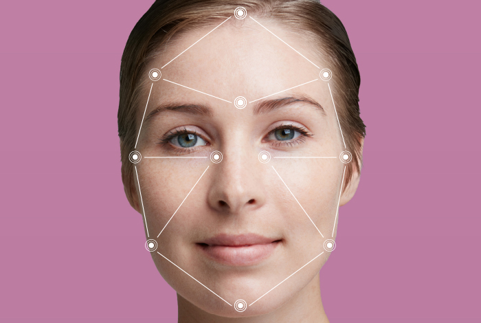 Close-up of woman's face as it's scanned by AI skin analysis tool. 