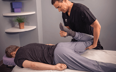 Therapist performing stretch to help improve client's mobility. 