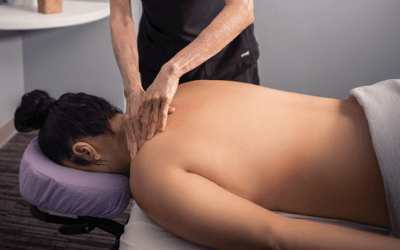 Woman relaxing as her neck is massaged by therapist. 