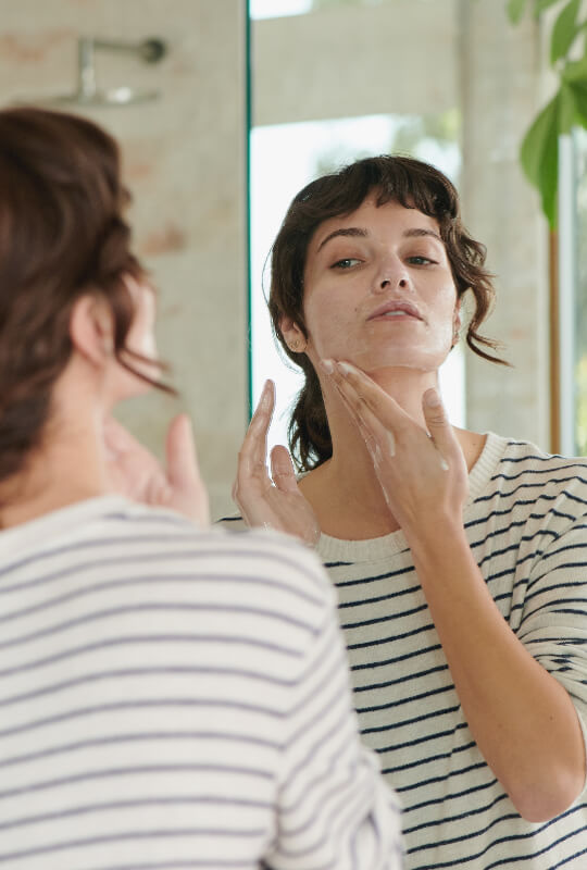Woman applying skin care product