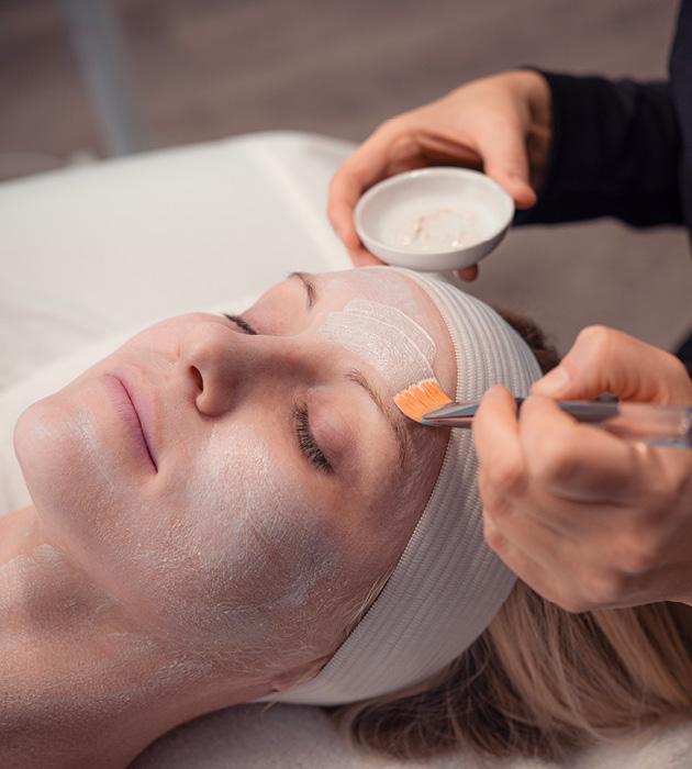 Close-up of woman receiving facial service from Massage Envy esthetician. 