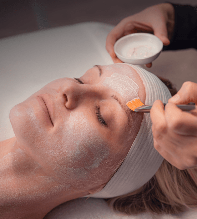 Woman relaxing during facial service at Massage Envy. 