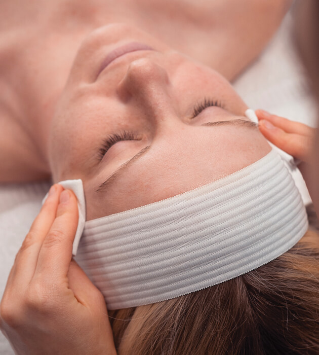 Close-up of woman's face during a facial session at Massage Envy. 
