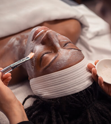 Woman with her eyes closed during facial service at Massage Envy. 