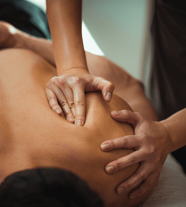 Massage therapist massaging a client's back. 
