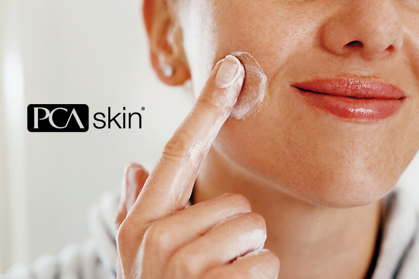 Woman applying PCA Skin care product to her cheek